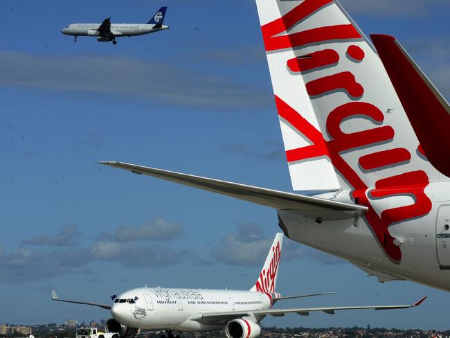 Two planes sporting the new branding for the Virgin Australia airline, replacing Virgin Blue and V Australia brands at Sydney Airport, Sydney, Wednesday, May 4, 2011. (AAP Image/Dean Lewins) NO ARCHIVING