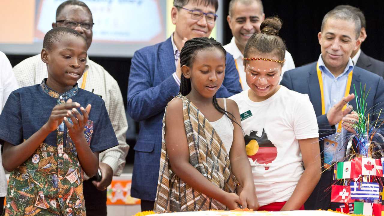 Cutting the cake are (from left) Enock Mukeba, Mary Inkindi and Evie Adams on Harmony Day celebrations at Darling Heights State School, Wednesday, March 14, 2019. Picture: Kevin Farmer