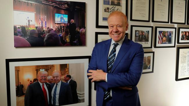 Anthony Pratt, with photos of him and US President Donald Trump, at the Visy office in Melbourne. Picture: Stuart McEvoy