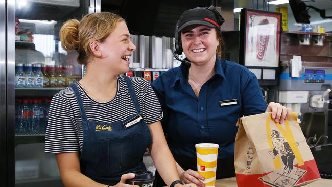 McDonald's staff members Chelsea Pearmine and Madeline Bamblett hand out orders of coffee and a toastie and a Big Mac and coke to customers at the Gordonvale restaurant. Picture: Brendan Radke