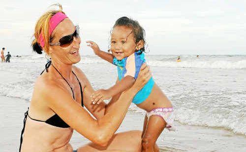 Melissa Richardson and Maylee Wade enjoy a swim at Nielson’s Beach after the tsunami warning was lifted yesterday afternoon. Picture: Darryn Smith