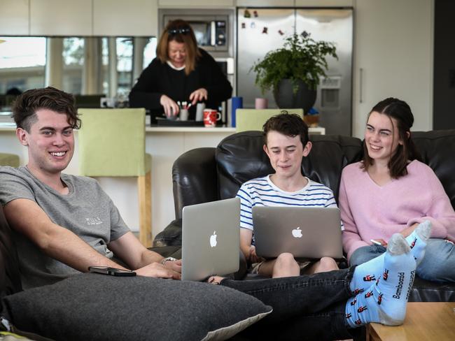 Siblings Will 18, Harry 13 and Sophie 16 Faulkner with their devices at home Sunday, August 26, 2018, mum Katherine. Photo: AAP/Mike Burton