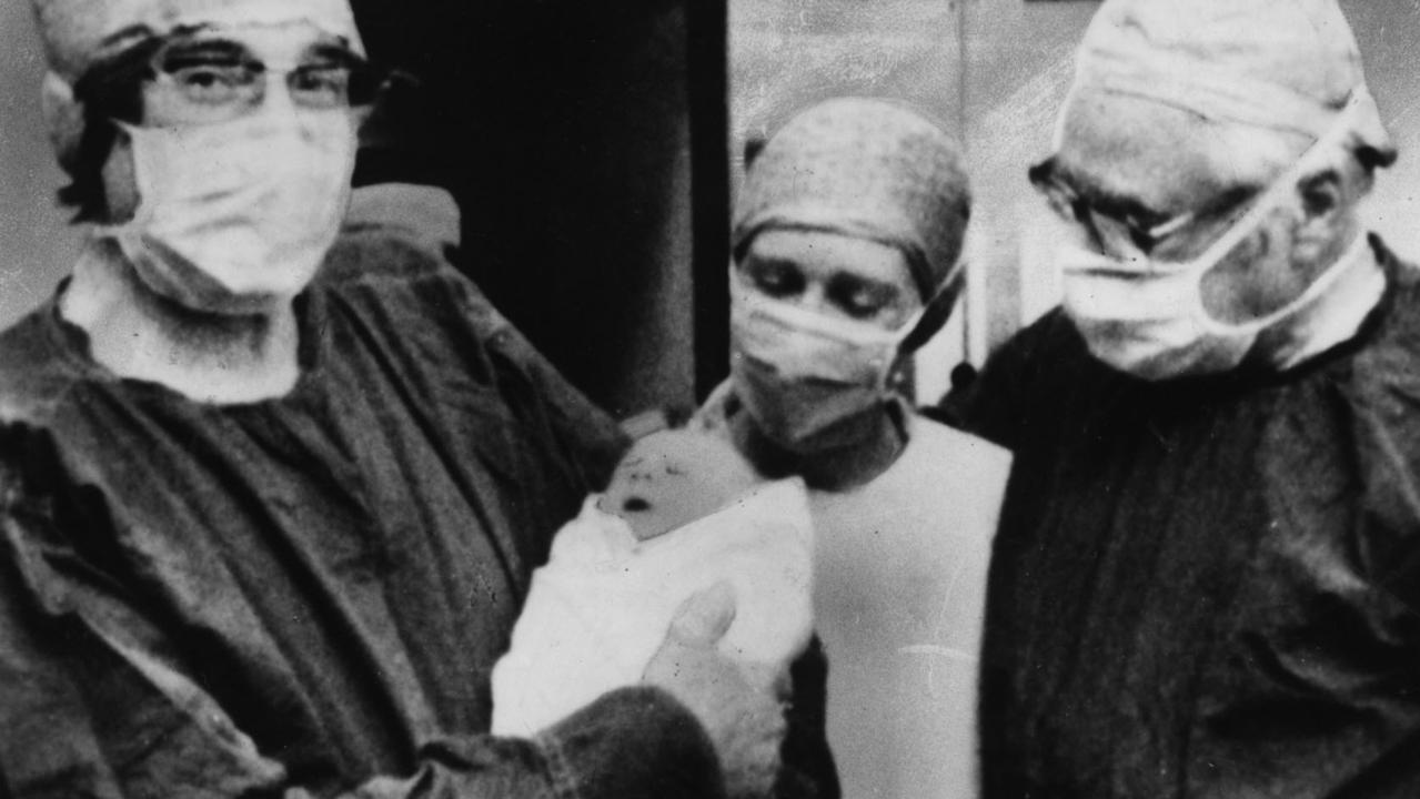Cambridge scientist Professor Robert Edwards holding baby Louise Joy Brown, with unnamed midwife and fertility specialist Dr Patrick Steptoe following her 25 Jul 1978 birth at Oldham General Hospital, world's first IVF baby.