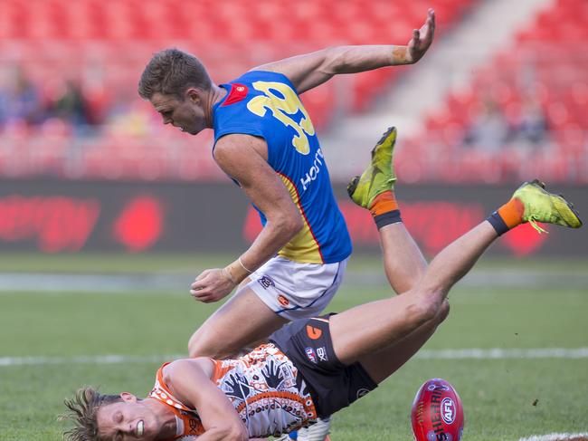 Lachie Whitfield of the Giants and Nick Holman of the Suns contest the ball during the Round 11 AFL match between the GWS Giants and the Gold Coast Suns at the Sydney Showground Stadium in Sydney, Saturday, June 1, 2019. (AAP Image/Craig Golding)