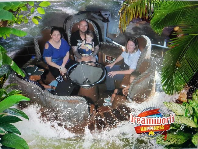 Mr Lovett with his daughter on his lap during the Thunder River Rapids ride. Picture: Jesse Lovett.