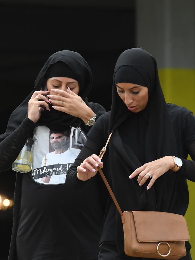 Women grieve outside mosque.