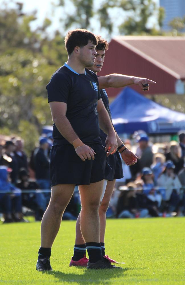 Harper Enasio (right) instructs flanker Lincoln Manuel (left) in round 1 of the 2024 GPS rugby season.