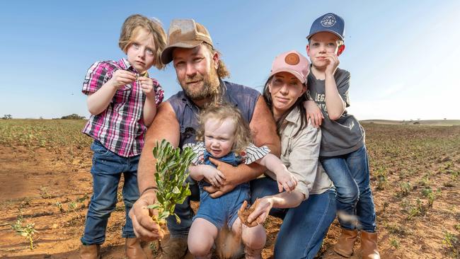 Ben and Jennifer Richie, with their children Oliver, 7 Chelsea 5, Georgia 2 with a bean crop on their Apilla farm. Picture: Ben Clark