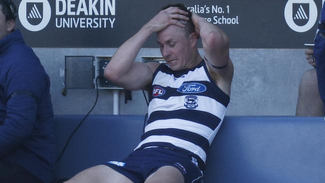 Mitch Duncan holds his head after the rough tackle. Picture: Daniel Pockett/Getty Images