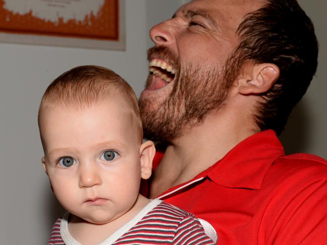 Kurt Fearnley with the love of his life, nine month old son Harry. Picture by Peter Lorimer.