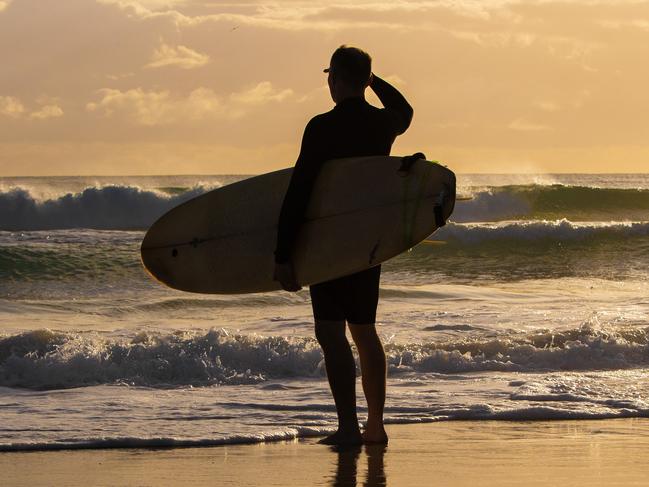 Q WEEKEND Sunrise, people walking on the beach at Currumbin for a story about daylight saving.Picture: NIGEL HALLETT