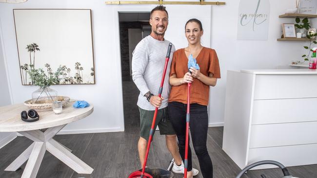 Isaac Lappin and Aimee Wells from C&K Property in Withcott finish cleaning their premises. Monday, February 28, 2022. Picture: Nev Madsen.