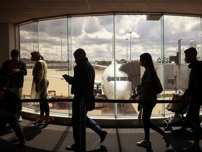 Travellers from Sydney have their permits checked in the Qantas terminal at Melbourne Airport. Picture: Ian Currie