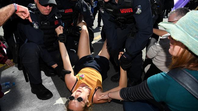 A climate change protester is removed by Police during a demonstration on Princess Bridge, Melbourne. Picture: AAP Image/James Ross