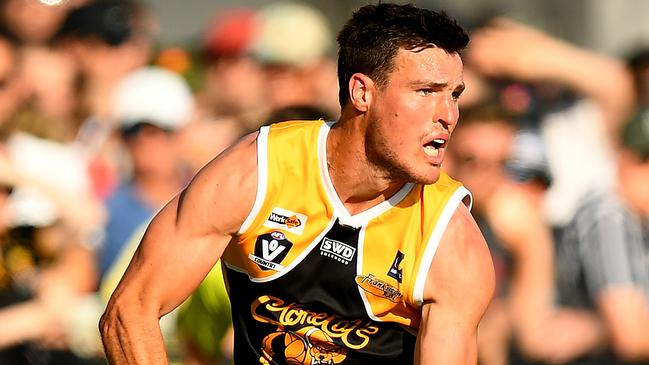 Blake Mullane of the Stonecats handballs during the 2023 MPFNL Division One grand final. (Photo by Josh Chadwick)