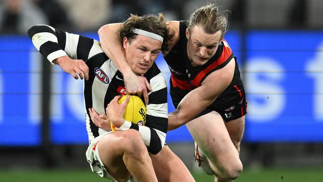 Jack Ginnivan is taken high by Mason Redman. Picture: Quinn Rooney/Getty Images.