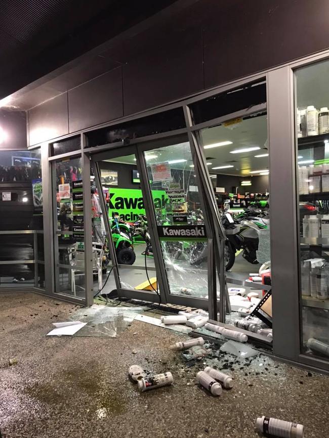 The damage left behind at Mackay Kawasaki after thieves used a stolen red LandCruiser to ram and raid the store and steal a motorbike.