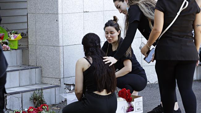 Family and friends at the vigil site. Picture: Adam Yip