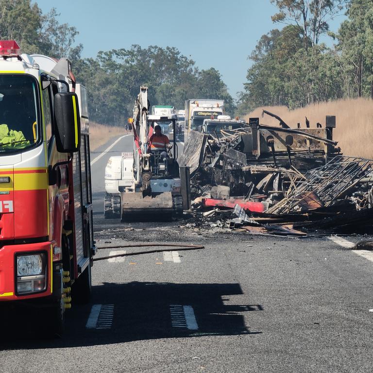 Claytons towing at work clearing the wreckage of a fiery two truck crash on the Bruce Highway, 37km south of Miriam Vale on August 5. Picture: Rodney Stevens