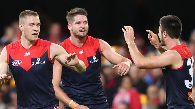 Melbourne players celebrate one of their many goals against the Suns. Picture: Getty Images