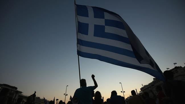 Last chance ... A man waves a Greek flag in front of the Greek parlaiment during a pro-european rally.