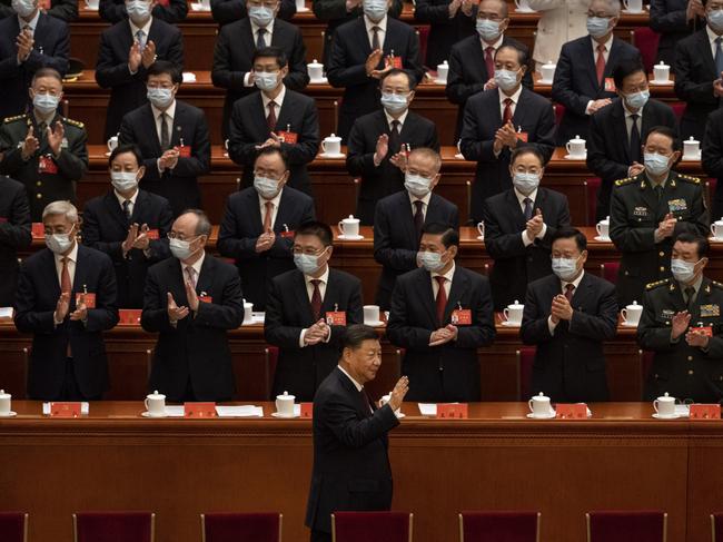 BEIJING, CHINA - OCTOBER 16: Chinese President Xi Jinping is applauded as he waves to senior members of the government upon arrival at the Opening Ceremony of the 20th National Congress of the Communist Party of China at The Great Hall of People on October 16, 2022 in Beijing, China. Xi Jinping is widely expected to secure a third term in power. (Photo by Kevin Frayer/Getty Images)