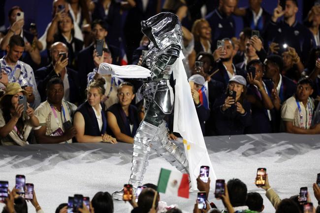 PARIS, FRANCE - JULY 26: The Olympic Flag is presented by the The Horsewoman at Place du Trocadero during the opening ceremony of the Olympic Games Paris 2024 on July 26, 2024 in Paris, France. (Photo by Matthew Stockman/Getty Images)