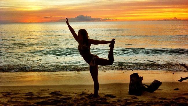 Amy Coghlan from Touch of Spirit Tours performing yoga at sunset. Picture: Supplied