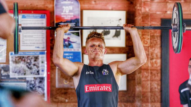 Adam Treloar lifts weights during a training circuit at Falls Creek. Picture: Colleen Petch