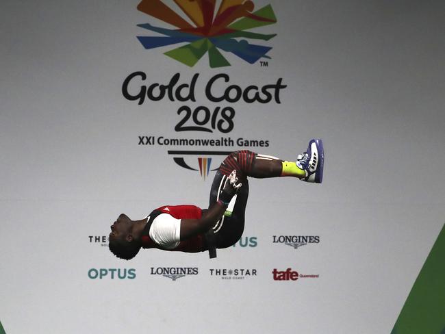 Cameroon's David Petit Minkoumba makes a somersault soon after a successful lift in Men's 94Kg Weightlifting final during the Commonwealth Games, in Gold Coast, He disappeared soon after. Picture: Manish Swarup