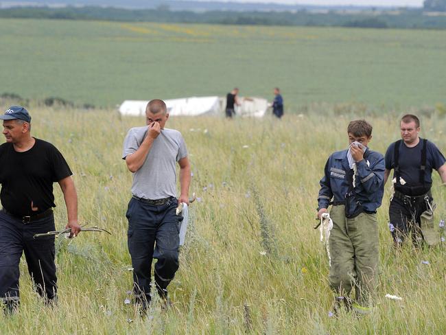 People search for bodies near the wreckage of Flight MH17