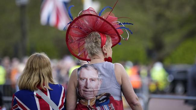 Royalists gather on The Mall, adorned with novelty crowns, glasses wigs and flags. Picture: Getty Images