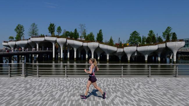 A jogger runs past Little Island, a new, free public park in Hudson River Park in New York. Picture: AFP