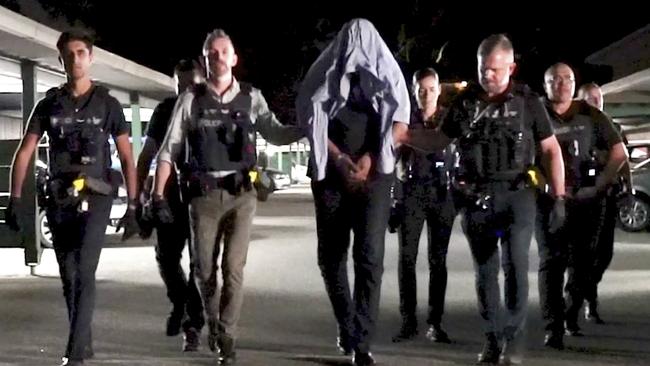 Majid Jamshidi Doukoshkan, centre, who was released from immigration detention, has been arrested along with two other men for the alleged violent bashing and robbery of an elderly cancer survivor.
