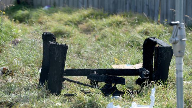 The burnt remains of a sofa in the backyard. Picture: Andrew Henshaw