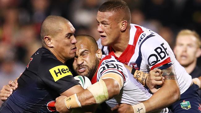 Sam Moa puts some Rooster gruntil into tackling Panther Lelani Latu during the round 22 NRL match at Pepper Stadium. Picture: Brendon Thorne/Getty Images.