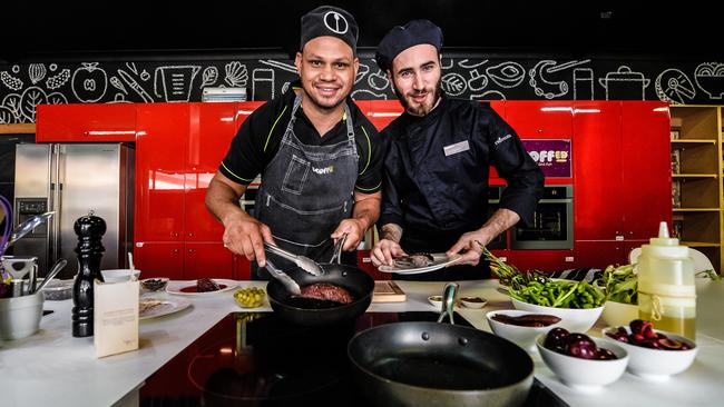 Daniel Motlop and Lachlan Mackinnon in the kitchen at Scoffed Cooking School. Picture: AAP/Roy VanDerVegt