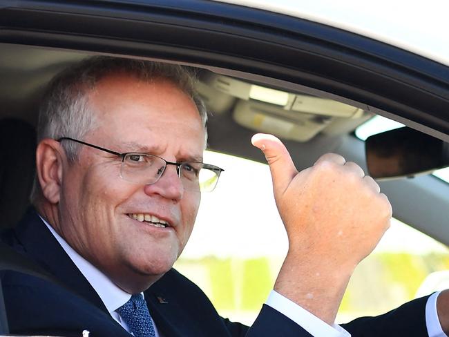 Australian Prime Minister Scott Morrison drives a hydrogen-powered car around a Toyota test track in Melbourne on November 9, 2021, after the government's launch of it's Future Fuels strategy. (Photo by William WEST / AFP)