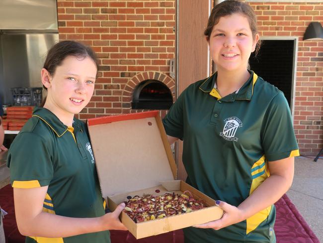 St Patrick's Year 6 students Chloe Knight and Ruby Moona with their Hawaiian pizza cooked in the wood-fired ovens in Hovell Tree Park.