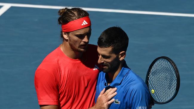 MELBOURNE, AUSTRALIA - JANUARY 24: Novak Djokovic of Serbia is embraced by Alexander Zverev of Germany after retiring from the Men's Singles Semifinal during day 13 of the 2025 Australian Open at Melbourne Park on January 24, 2025 in Melbourne, Australia. (Photo by Quinn Rooney/Getty Images)