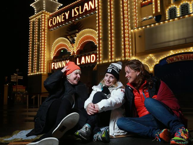 Ms Holgate, pictured with fellow chief executives Martine Jager and Holly Kramer, displays her Collingwood pride during Vinnies’ CEO Sleepout at Luna Park. Picture: Britta Campion