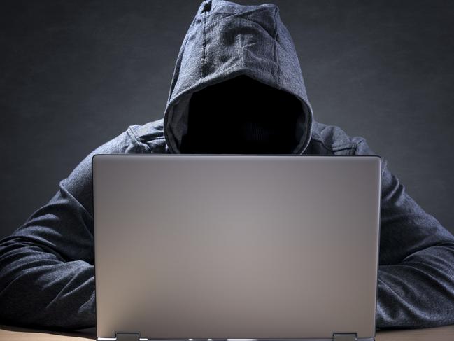 Computer hacker stealing data from a laptop concept for network security, identity theft and computer crime