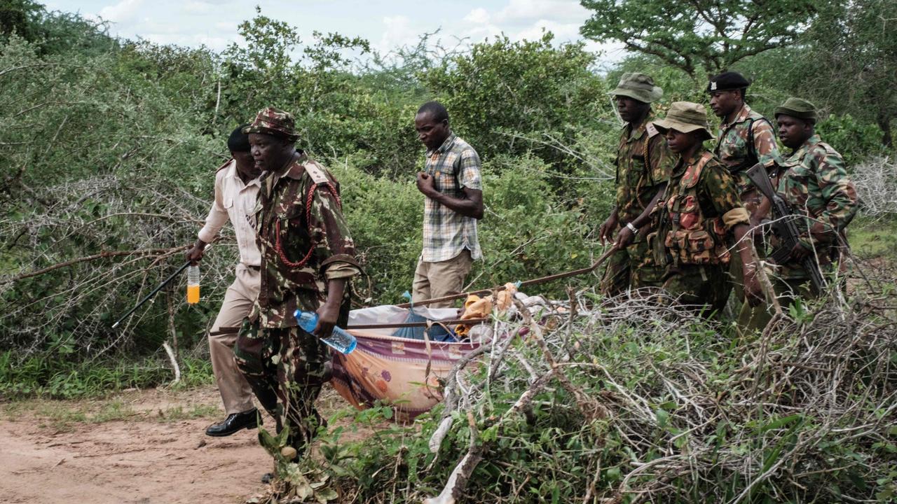 A rescued young person is carried from the forest. Picture: AFP