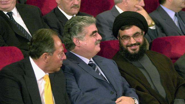 Then Lebanese president Emile Lahoud (L) and prime minister Rafiq Hariri (C) with Hezbollah's leader Hassan Nasrallah in 2021. Picture: AFP.