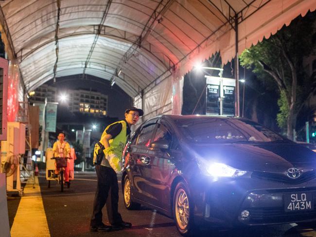 A police officer checks vehicles passing through a checkpoint in front of the St. Regis Hotel, where Kim is staying. Picture: Chris McGrath/Getty Images