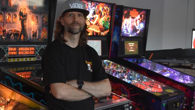 Arcade Box owner Andre Cooper with some of his prized pinball machines.