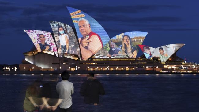 Images of the pandemic are projected on the Sydney Opera House on Monday to celebrate the reopening as the country prepares for life after the pandemic. Picture: Getty Images