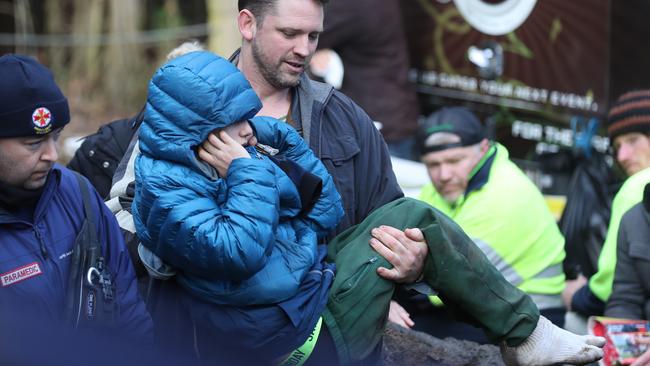 The teenager covered his ears after being brought to the rescue base. Picture: David Crosling