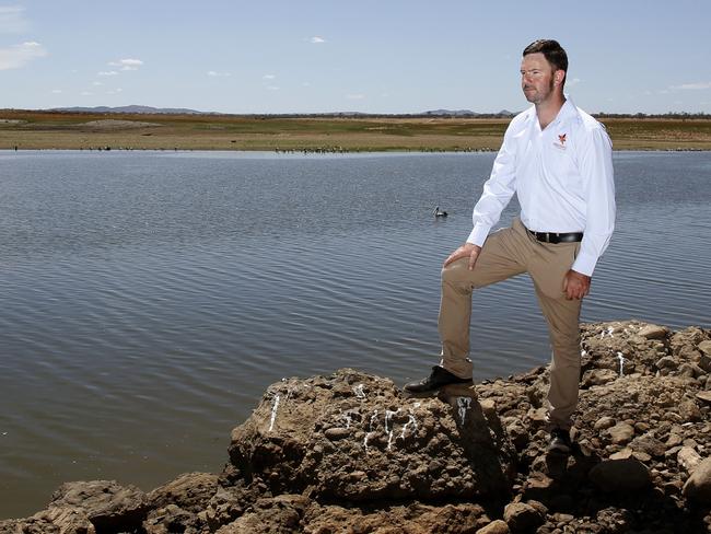 Lake Keepit Grounds and Maintenance Supervisor, Nathan Easey, inspects some of the fish-kill near the dam wall as the level drops to 0.5 of a per cent. Picture: Peter Lorimer.