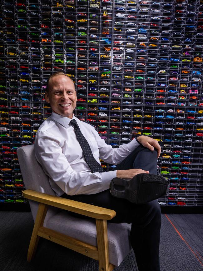 Mr Drake poses with his extensive toy car collection. Picture: Tom Huntley